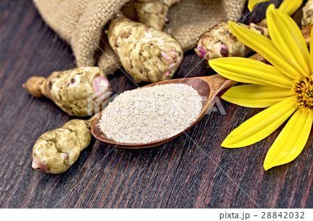 Flour of Jerusalem artichoke in spoon on board Flour of Jerusalem artichoke in spoon on board 28842032