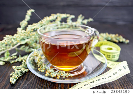 Tea with wormwood in glass cup and meter 28842199