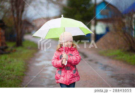 Smiling happy girl with green umbrella in spring Smiling happy girl with green umbrella in spring 28843055