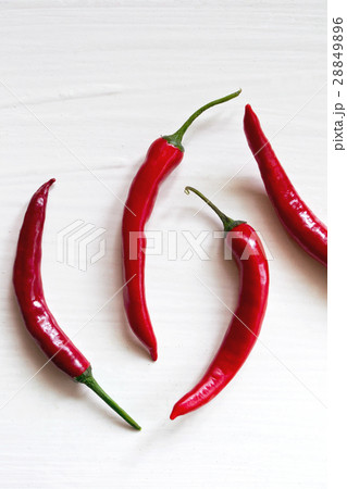 Red chili peppers on white Red chili peppers on white 28849896