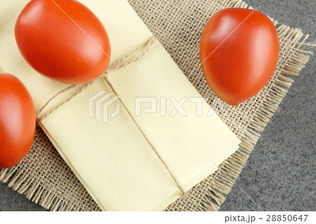 Tomatoes and sheets for lasagne on sackcloth. 28850647