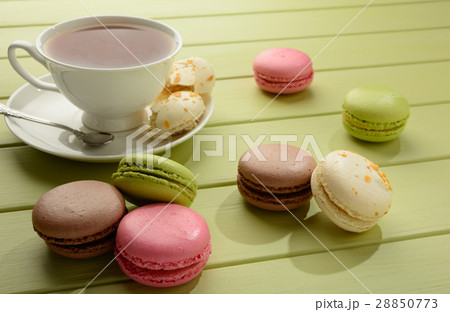Macaroons and cup of tea on a wooden table. 28850773