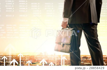 Businessman standing with back against city 28856429