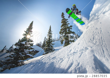 Flying snowboarder in the mountains 28857035