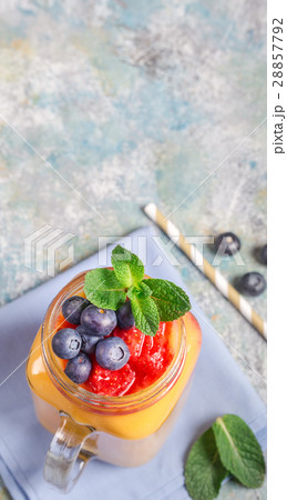 Mango drink and blueberries above Mango drink and blueberries above 28857792