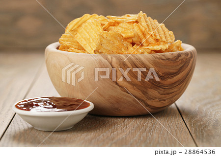 rippled potato chips with paprika and bbq sauce in rippled potato chips with paprika and bbq sauce in 28864536