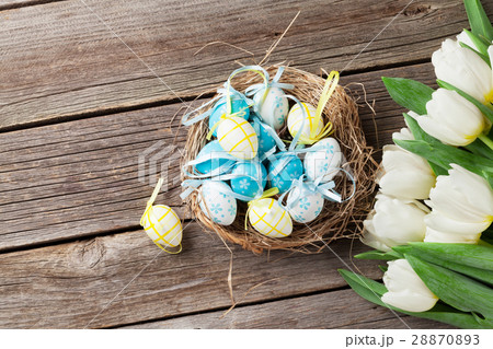 Easter eggs in nest and white tulips Easter eggs in nest and white tulips 28870893