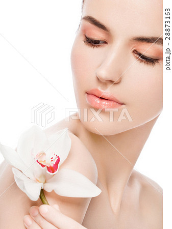 Beauty fashion model holding white orchid at spa Beauty fashion model holding white orchid at spa 28873163