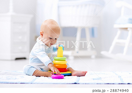 Baby playing with toy pyramid. Kids play Baby playing with toy pyramid. Kids play 28874940
