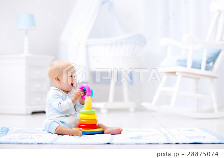 Baby playing with toy pyramid. Kids play Baby playing with toy pyramid. Kids play 28875074