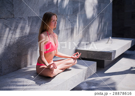 Serene meditating woman relaxing at luxury travel Serene meditating woman relaxing at luxury travel 28878616