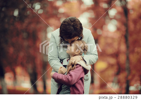 mother hugging her daughter, Autumn Park mother hugging her daughter, Autumn Park 28880329