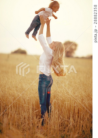 young mother hugging her daughter in a wheat field young mother hugging her daughter in a wheat field 28882358