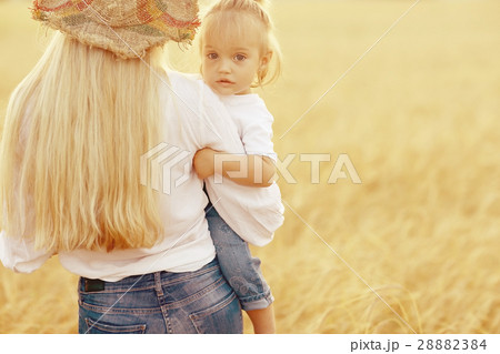 warm portrait of mother and daughter in country style in the field warm portrait of mother and daughter in country style in the field 28882384