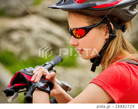Bikes cycling girl. Bicyclist girl watch on smart Bikes cycling girl. Bicyclist girl watch on smart 28882729