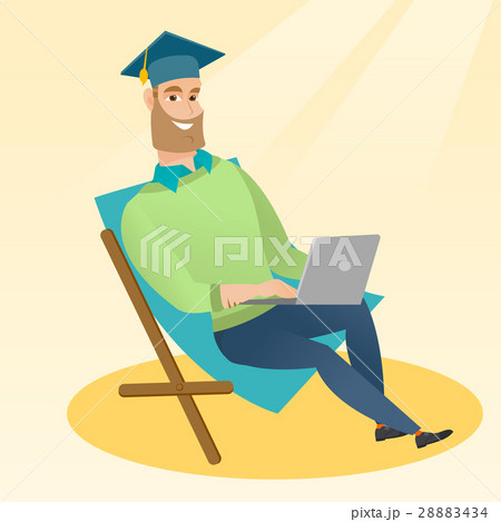 Graduate sitting in chaise lounge with laptop. 28883434