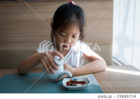 Asian Child, Girl, Pouring Soy Sauce Asian Child, Girl, Pouring Soy Sauce 28886734