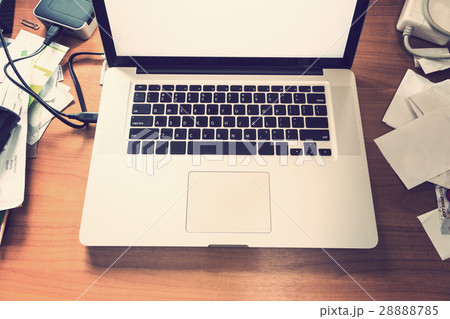 notebook or laptop computer on messy wooden desk notebook or laptop computer on messy wooden desk 28888785