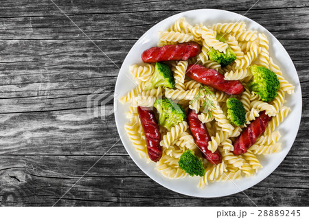 Pasta salad with broccoli and grilled sausages 28889245