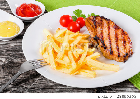 grilled pork chops on dish with french fries grilled pork chops on dish with french fries 28890305