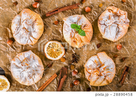 Сoconut puff pastries on a parchment paper Сoconut puff pastries on a parchment paper 28890458