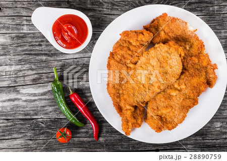 Fried chicken chops on a white dish, top view Fried chicken chops on a white dish, top view 28890759