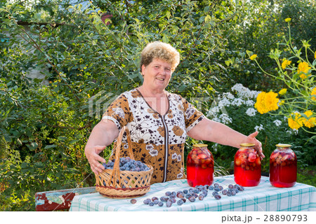 elderly woman with  jar of plum compote 28890793
