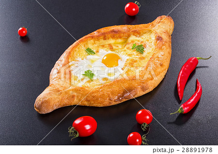 khachapuri with egg on black background 28891978