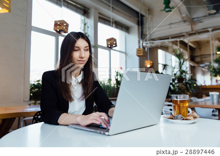 Young business woman sitting at table in cafe Young business woman sitting at table in cafe 28897446