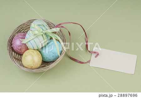 Colorful easter eggs in a basket with name tag Colorful easter eggs in a basket with name tag 28897696