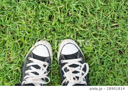 black sneakers on green grass 28901814