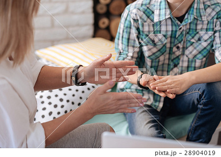 Close up of two pairs of hands while gesticulating 28904019
