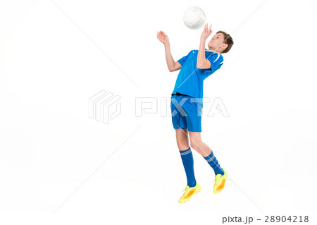 Young boy with soccer ball doing flying kick Young boy with soccer ball doing flying kick 28904218