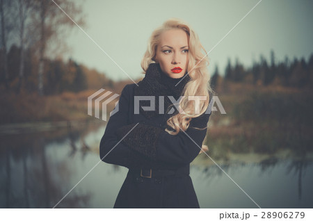 Beautiful elegant woman in a black coat 28906279