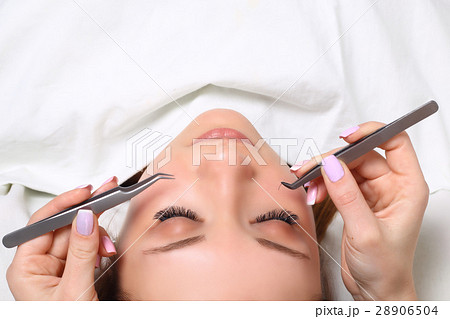Eyelash Extension Procedure. Woman Eye with Long 28906504
