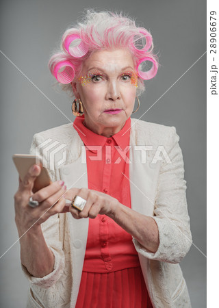 Trendy stylish old lady holding cellphone Trendy stylish old lady holding cellphone 28906679