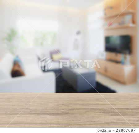 wooden table top with blur of modern living room 28907697