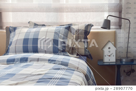 Cozy bedroom with pillows and reading lamp Cozy bedroom with pillows and reading lamp 28907770