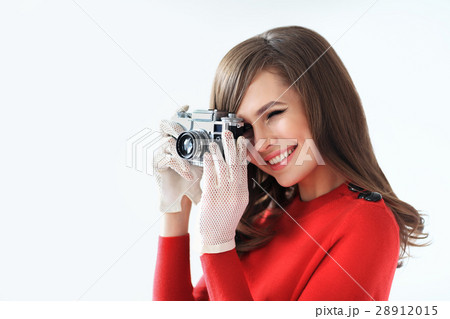 Retro style portrait of young beautiful woman taking photo with Retro style portrait of young beautiful woman taking photo with 28912015