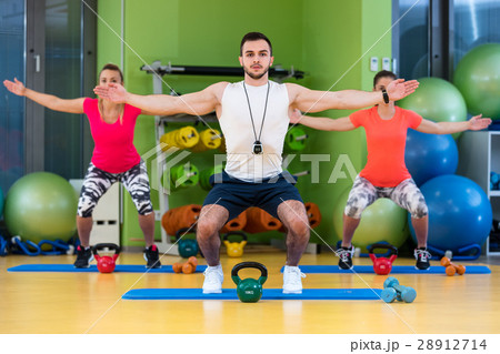 Kettlebells swing exercise man and woman workout 28912714