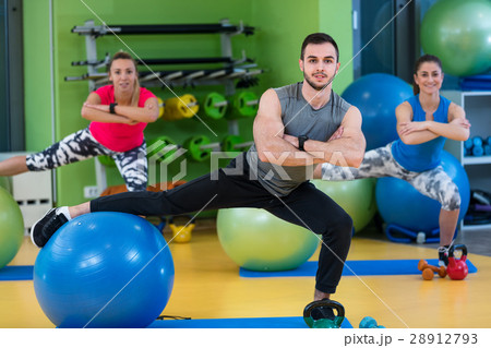 Portrait of happy group exercising on Swiss ball Portrait of happy group exercising on Swiss ball 28912793