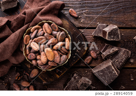 Cocoa beans and chocolate on wooden background 28914059