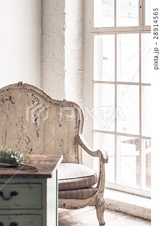 Armchair and a wooden table in a room 28914565
