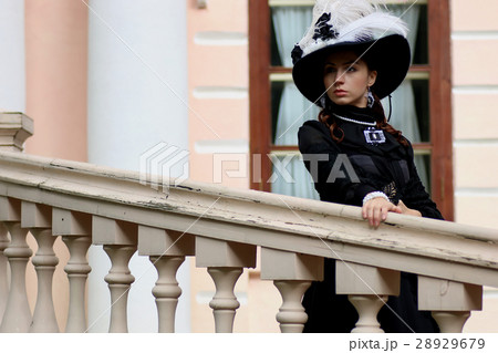 woman in vintage dress on porch of castle woman in vintage dress on porch of castle 28929679