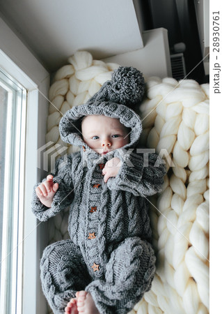 Small baby in knitted clothes 28930761