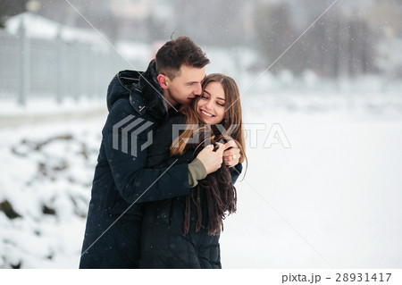couple posing in a snowy park couple posing in a snowy park 28931417