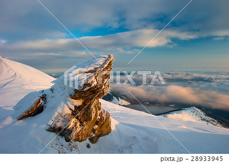 rock covered with snow and fog 28933945