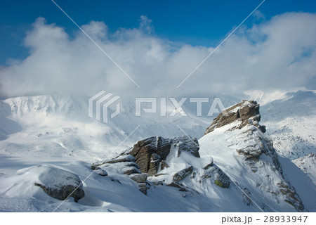 rock covered with snow and fog 28933947