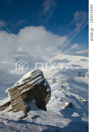 rock covered with snow and fog 28933949