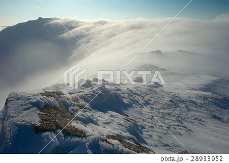 rock covered with snow and fog 28933952
